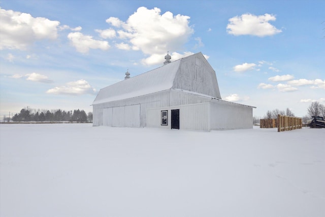 view of snow covered exterior featuring an outbuilding