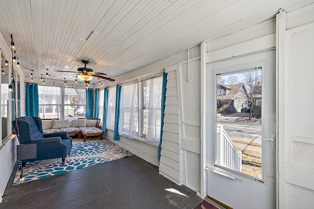 sunroom with wooden ceiling, a ceiling fan, and a wealth of natural light