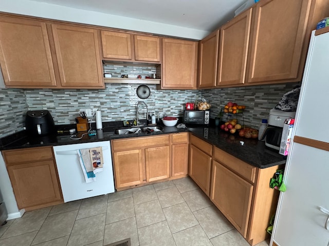 kitchen with white appliances, sink, decorative backsplash, and light tile patterned floors