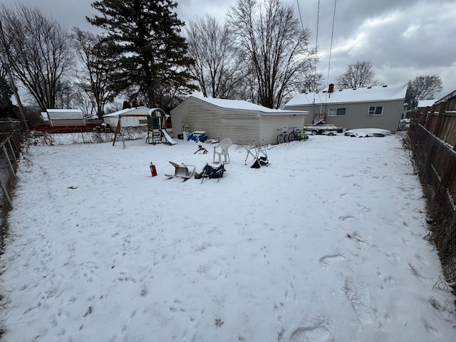 snowy yard with a playground