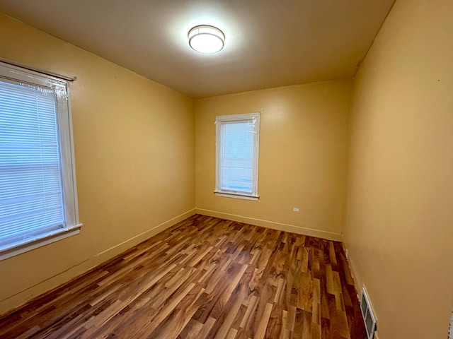 unfurnished room featuring wood-type flooring