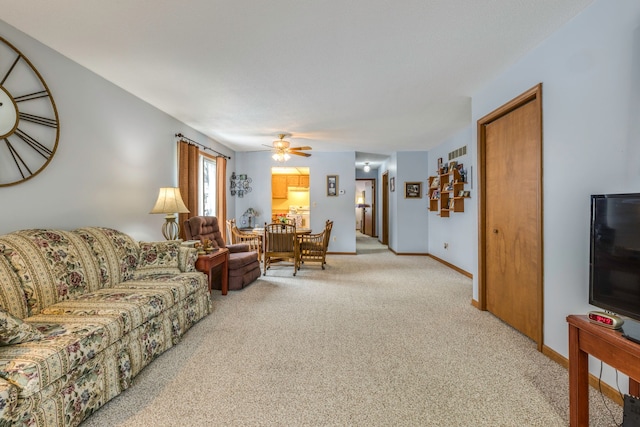 carpeted living room with ceiling fan