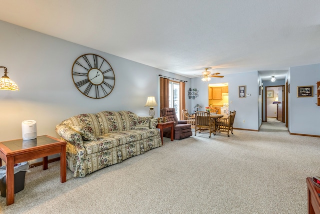 carpeted living room with ceiling fan