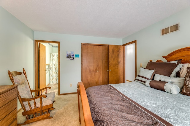 carpeted bedroom featuring a textured ceiling and a closet