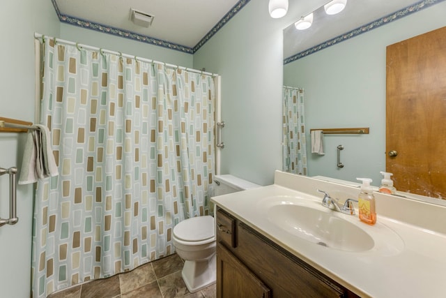 bathroom featuring vanity, toilet, and a shower with shower curtain