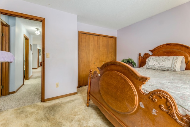 bedroom with light colored carpet, a closet, and a textured ceiling