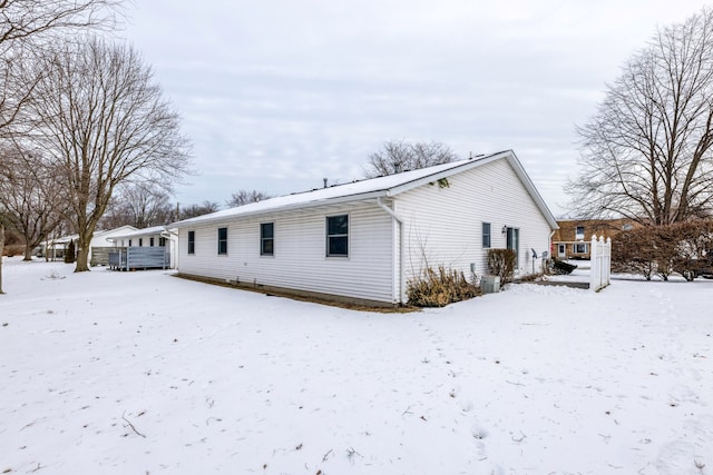 view of snow covered rear of property