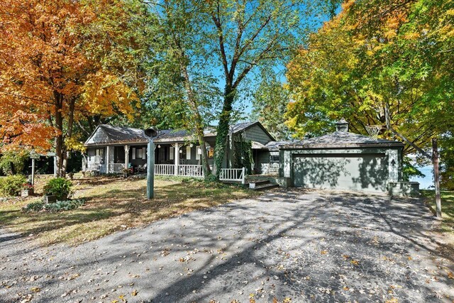 single story home featuring a garage and covered porch