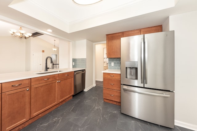 kitchen with lofted ceiling, sink, backsplash, hanging light fixtures, and stainless steel appliances