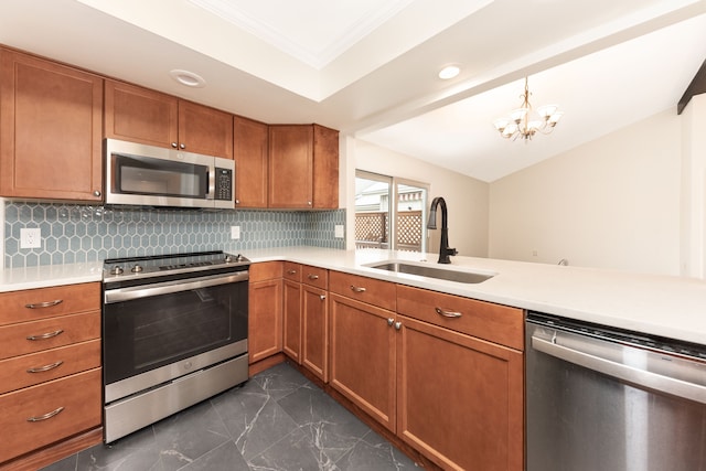 kitchen with pendant lighting, sink, backsplash, and stainless steel appliances