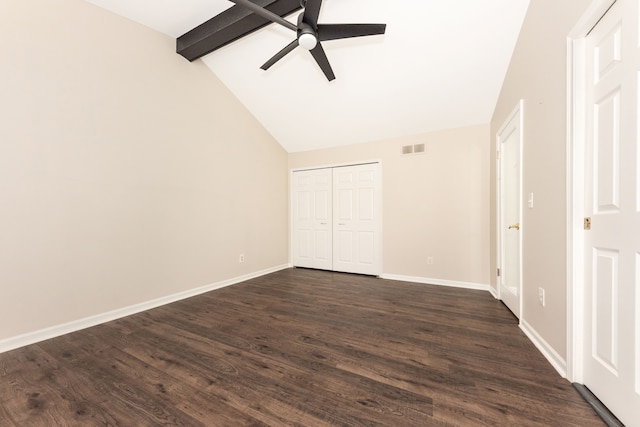 unfurnished bedroom featuring ceiling fan, dark hardwood / wood-style floors, lofted ceiling with beams, and a closet