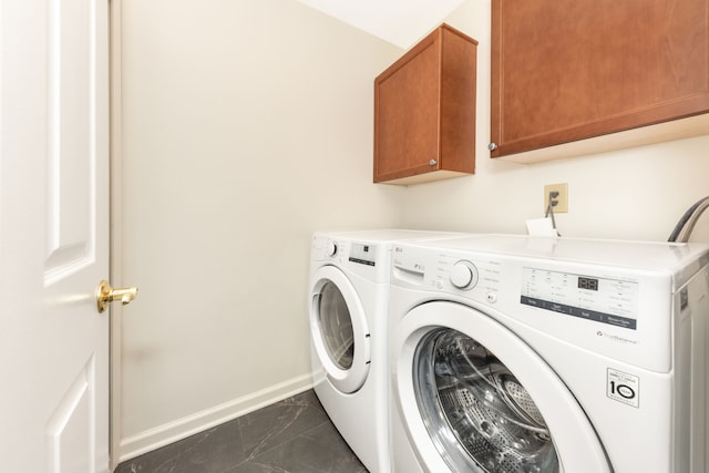 laundry room with cabinets and washing machine and dryer