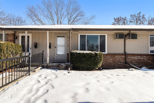 view of snow covered property entrance