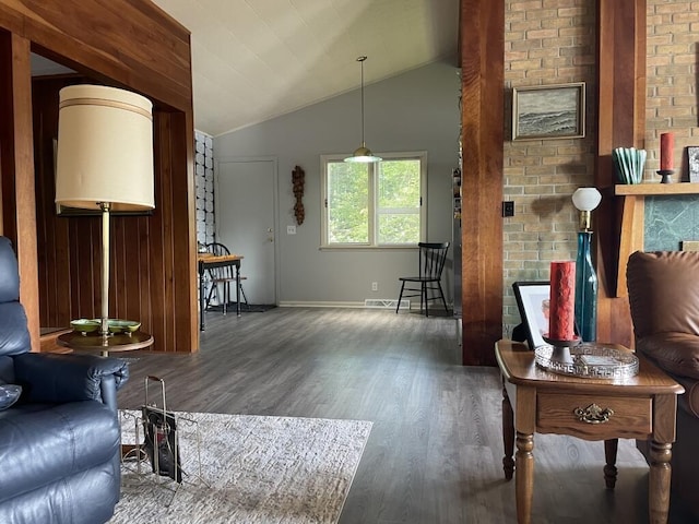 living room with dark wood-type flooring and vaulted ceiling