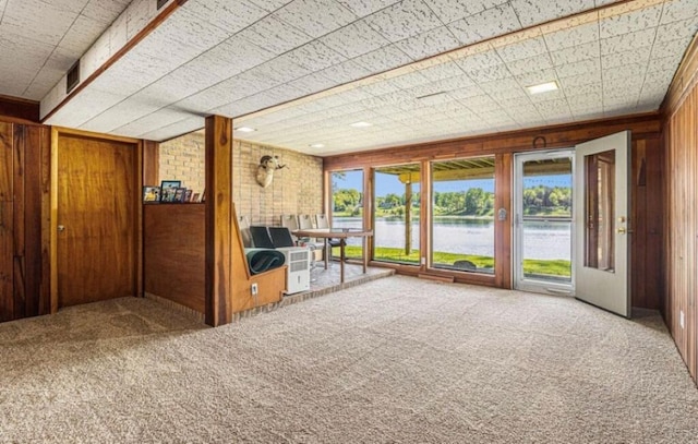 unfurnished sunroom with a water view