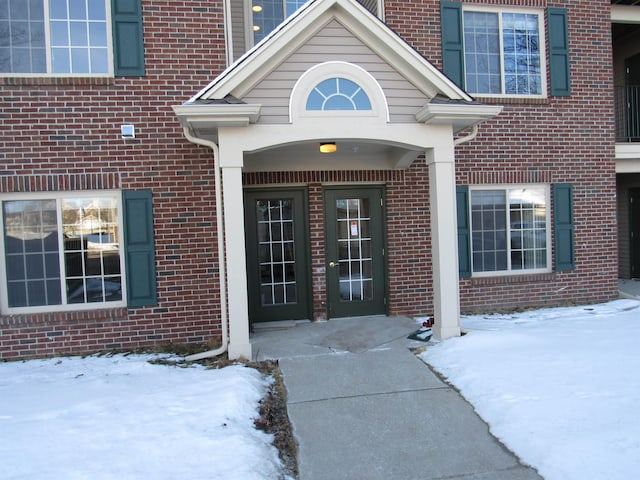 view of snow covered property entrance