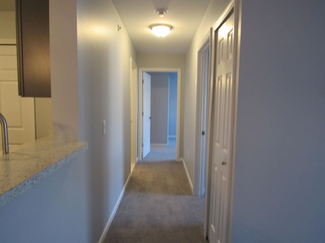 corridor with dark carpet