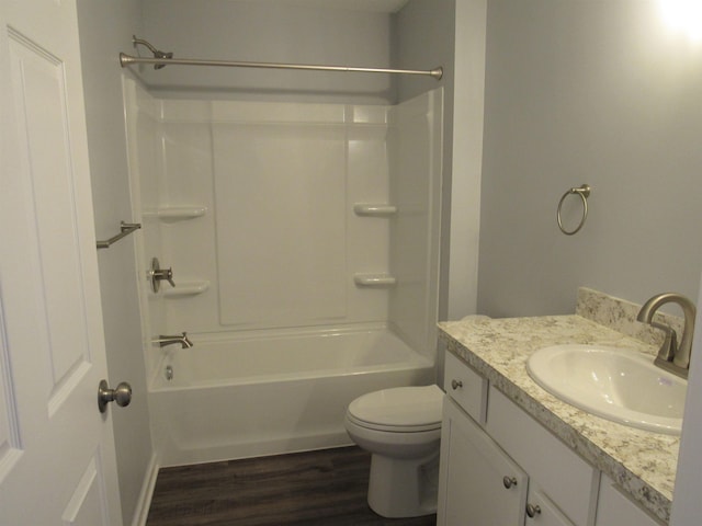 full bathroom with hardwood / wood-style flooring, shower / bathtub combination, vanity, and toilet