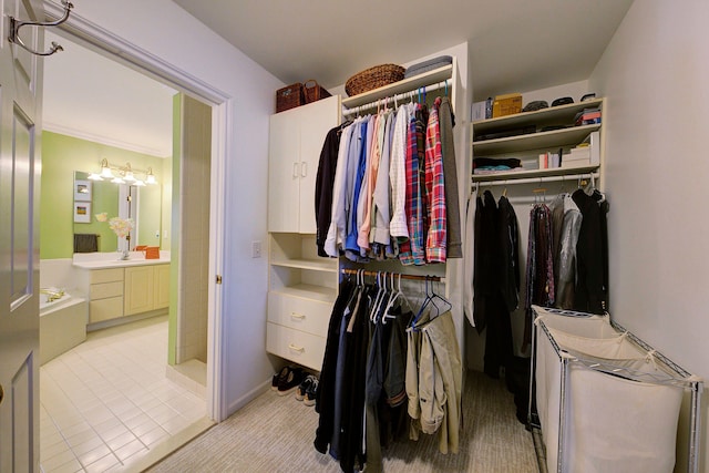 spacious closet with sink and light tile patterned floors