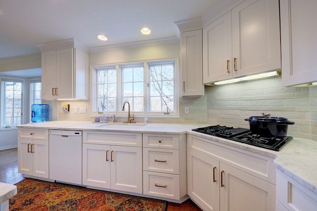 kitchen featuring white cabinetry, dishwasher, sink, and crown molding