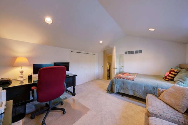 carpeted bedroom featuring vaulted ceiling and a closet