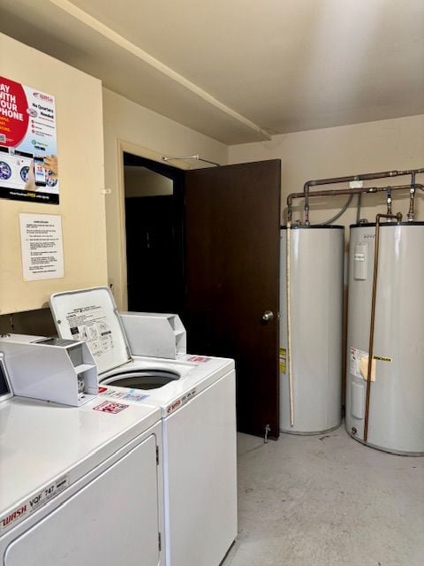 laundry area with water heater, electric water heater, and washing machine and clothes dryer