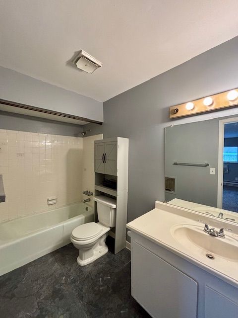 full bathroom with shower / tub combination, vanity, and toilet