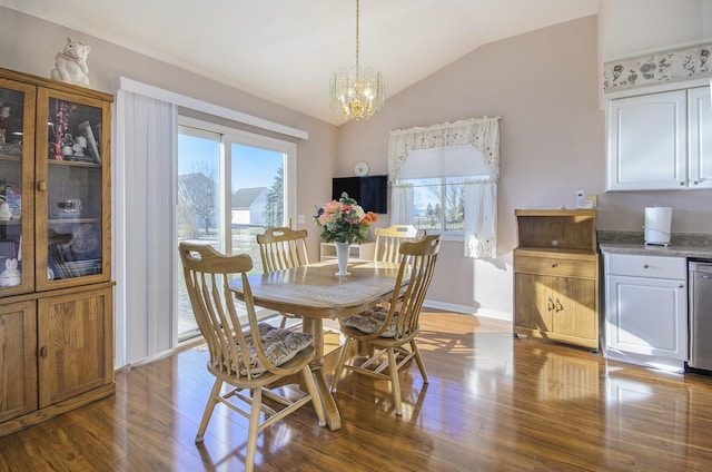 dining space with vaulted ceiling, a notable chandelier, and light hardwood / wood-style flooring