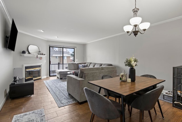 dining space with crown molding and an inviting chandelier