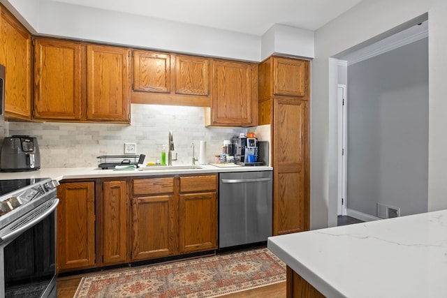 kitchen featuring sink, backsplash, and appliances with stainless steel finishes