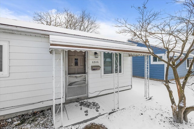 view of snow covered property entrance