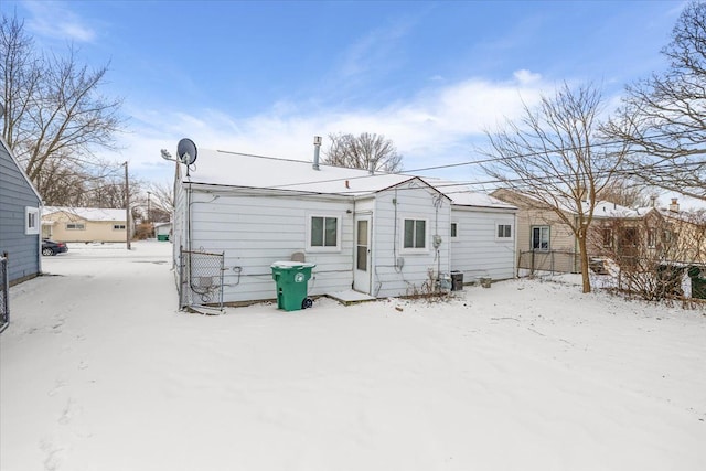 view of snow covered rear of property