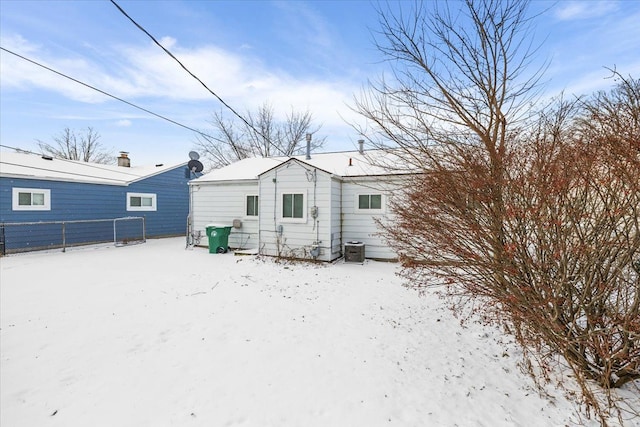 view of snow covered rear of property