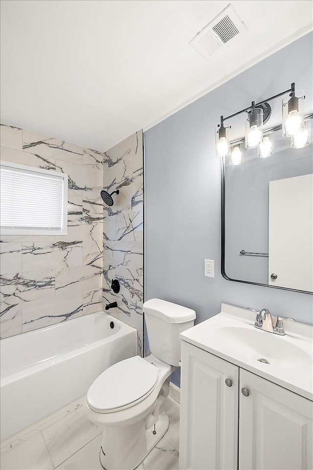 full bathroom with vanity, tiled shower / bath combo, and toilet