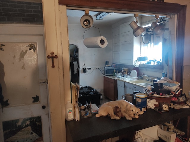 kitchen with brick wall and sink