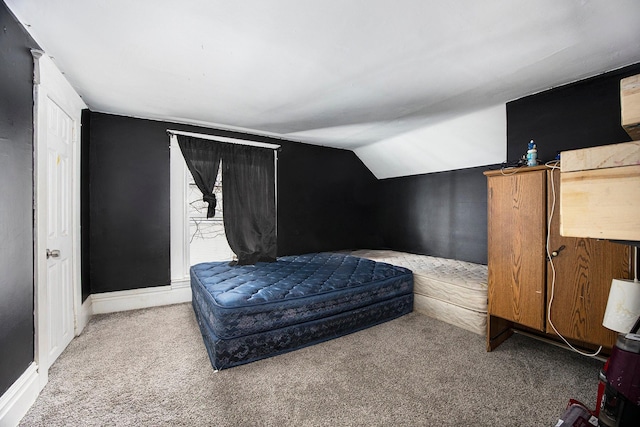 bedroom featuring carpet floors and lofted ceiling
