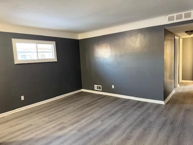 unfurnished room featuring wood-type flooring