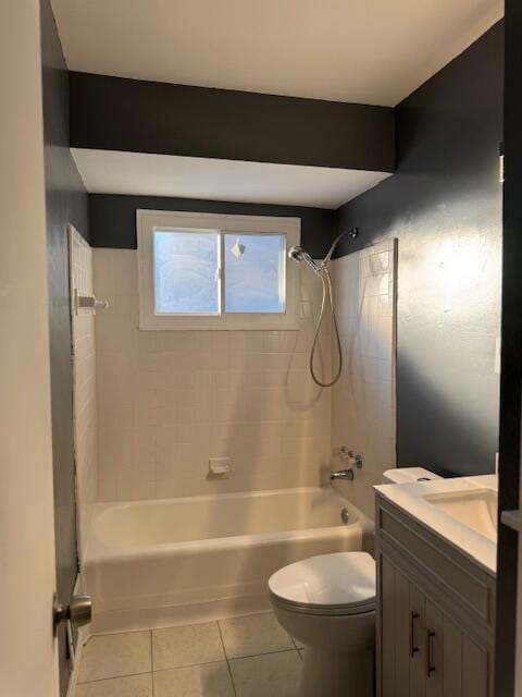 full bathroom featuring tile patterned flooring, vanity, tiled shower / bath combo, and toilet