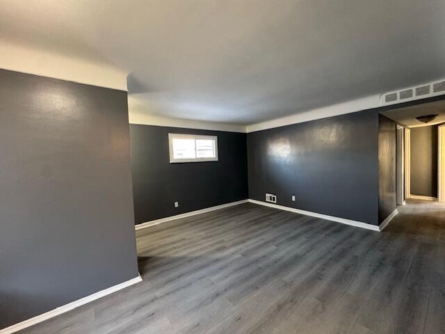 unfurnished room featuring dark hardwood / wood-style flooring