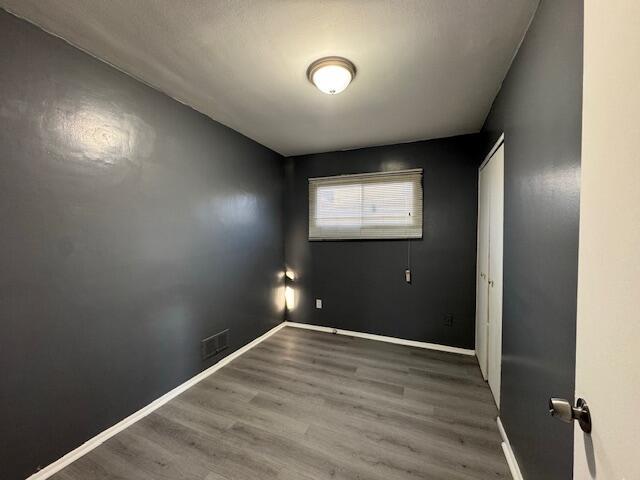 unfurnished room featuring hardwood / wood-style flooring