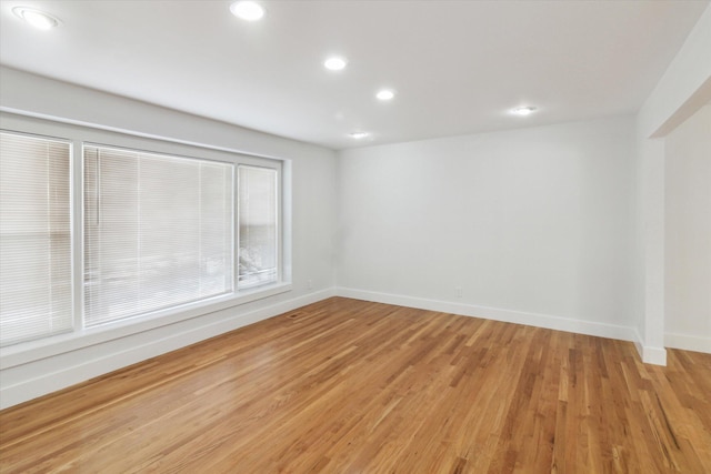 empty room with hardwood / wood-style flooring