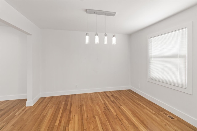 spare room featuring light hardwood / wood-style floors