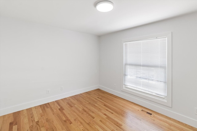 spare room with hardwood / wood-style flooring