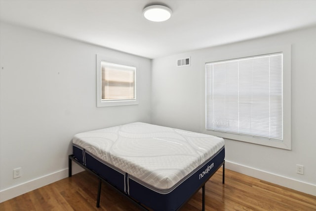 bedroom with hardwood / wood-style flooring