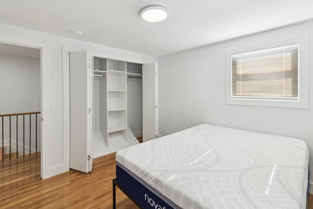 bedroom with hardwood / wood-style flooring and a closet