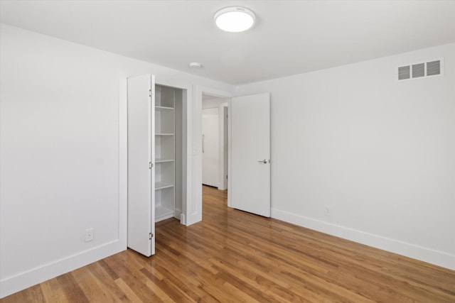 unfurnished bedroom with wood-type flooring