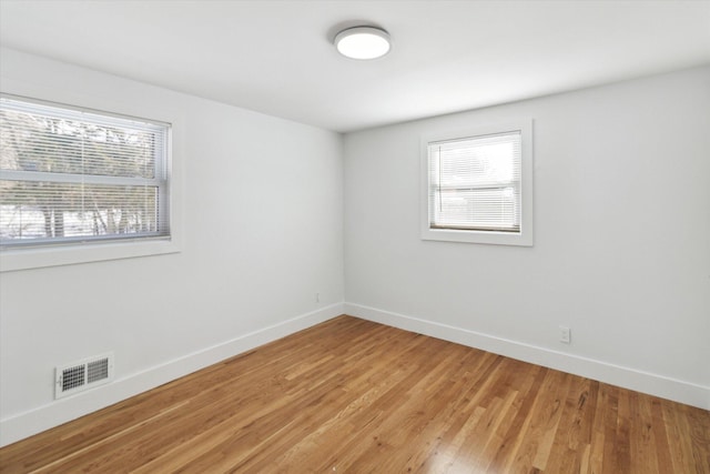 empty room with hardwood / wood-style flooring