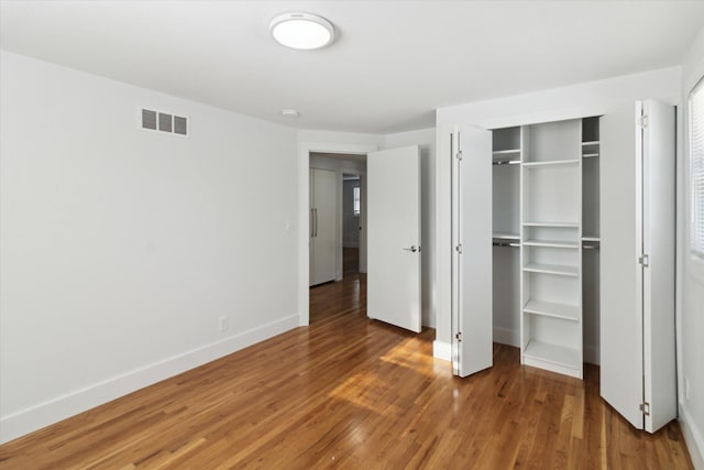 unfurnished bedroom featuring hardwood / wood-style flooring