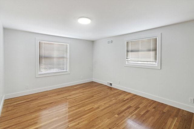 unfurnished room with light hardwood / wood-style floors