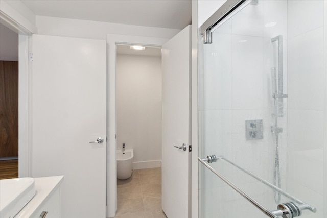 bathroom featuring a shower with door, a bidet, tile patterned flooring, and vanity